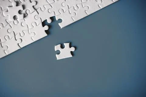 Clean puzzle elements on the red background. Empty puzzle piece on the tabl.. Stock Photos
