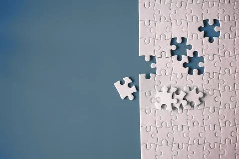 Clean puzzle elements on the red background. Empty puzzle piece on the tabl.. Stock Photos