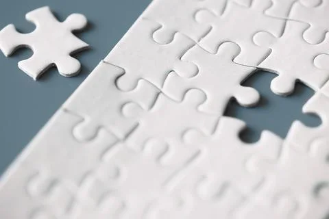 Clean puzzle elements on the red background. Empty puzzle piece on the tabl.. Stock Photos
