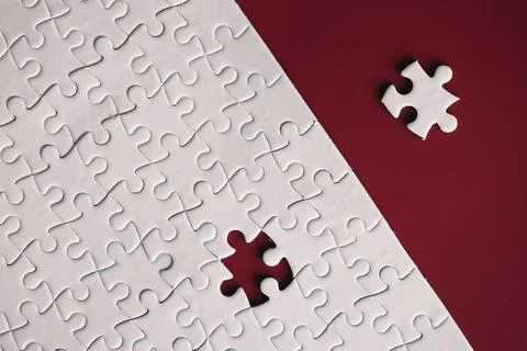 Clean puzzle elements on the red background. Empty puzzle piece on the tabl.. Stock Photos