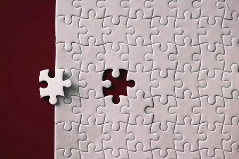 Clean puzzle elements on the red background. Empty puzzle piece on the tabl.. Stock Photos