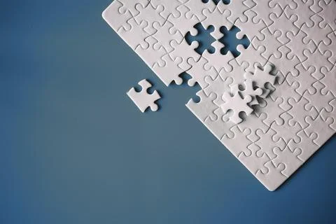 Clean puzzle elements on the red background. Empty puzzle piece on the tabl.. Stock Photos