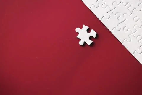 Clean puzzle elements on the red background. Empty puzzle piece on the tabl.. Stock Photos