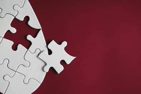 Clean puzzle elements on the red background. Empty puzzle piece on the tabl.. Stock Photos