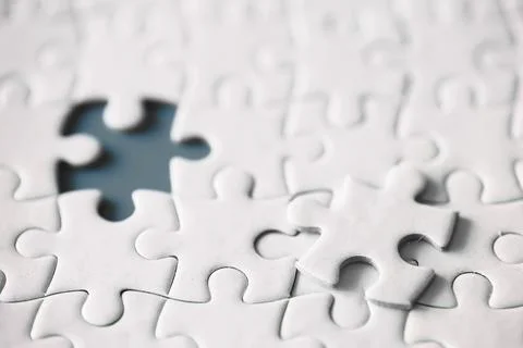 Clean puzzle elements on the red background. Empty puzzle piece on the tabl.. Stock Photos