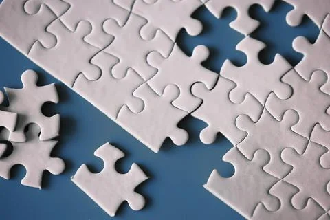 Clean puzzle elements on the red background. Empty puzzle piece on the tabl.. Stock Photos