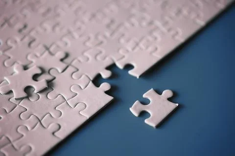 Clean puzzle elements on the red background. Empty puzzle piece on the tabl.. Stock Photos