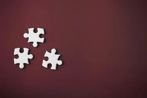 Clean puzzle elements on the red background. Empty puzzle piece on the tabl.. Stock Photos