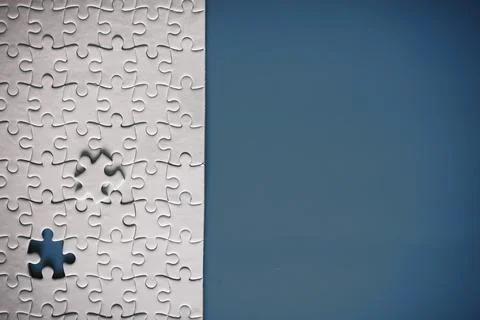 Clean puzzle elements on the red background. Empty puzzle piece on the tabl.. Stock Photos