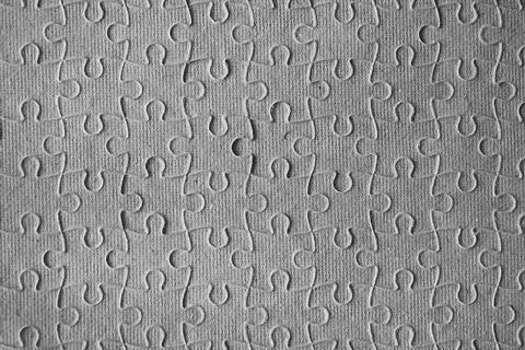 Clean puzzle elements on the red background. Empty puzzle piece on the tabl.. Stock Photos