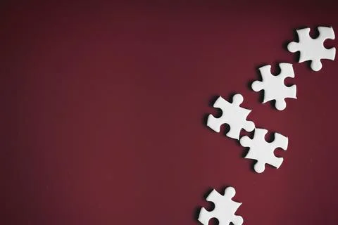 Clean puzzle elements on the red background. Empty puzzle piece on the tabl.. Stock Photos