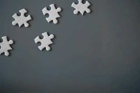 Clean puzzle elements on the red background. Empty puzzle piece on the tabl.. Stock Photos
