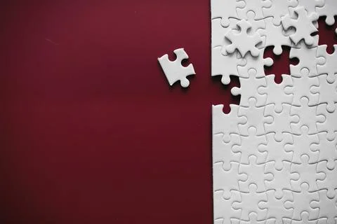 Clean puzzle elements on the red background. Empty puzzle piece on the tabl.. Stock Photos