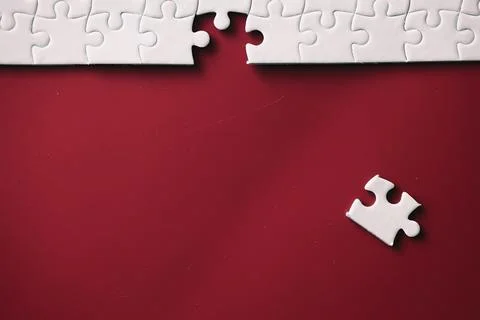 Clean puzzle elements on the red background. Empty puzzle piece on the tabl.. Stock Photos