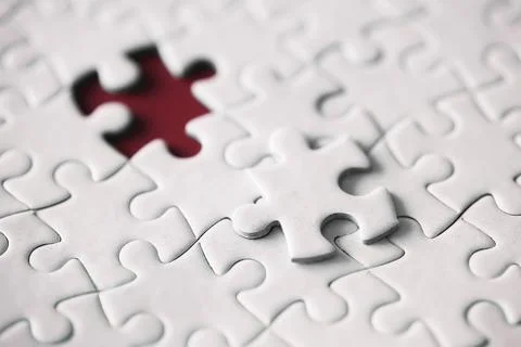 Clean puzzle elements on the red background. Empty puzzle piece on the tabl.. Stock Photos