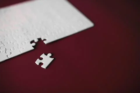 Clean puzzle elements on the red background. Empty puzzle piece on the tabl.. Foto stock