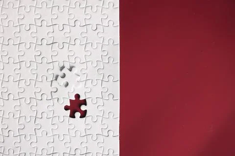 Clean puzzle elements on the red background. Empty puzzle piece on the tabl.. Foto stock