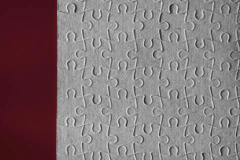 Clean puzzle elements on the red background. Empty puzzle piece on the tabl.. Foto stock