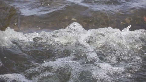 Clean rapid river water flowing close up. Pure water bubbling, slow motion Video stock 168582148