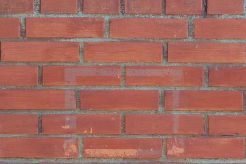 Clean red brick wall texture with even mortar lines, uniform courses, warm te Stock Photos