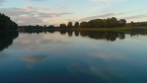 A clean river creating a reflection of the trees surrounding it. 스톡 동영상 113427217