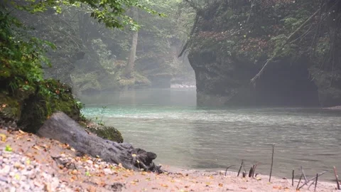 Clean river flowing downstream in narrow Alpine gorge between large boulders Stock Footage 140543070