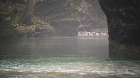 Clean river flowing downstream in narrow Alpine gorge between large boulders Stock Footage 140543157