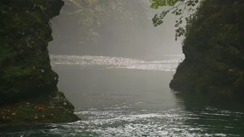 Clean river flowing downstream in narrow Alpine gorge between large boulders Stock Footage 140543739