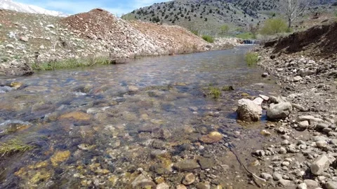 Clean river flows through the mountains to the plain Stockbeeldmateriaal 238032265