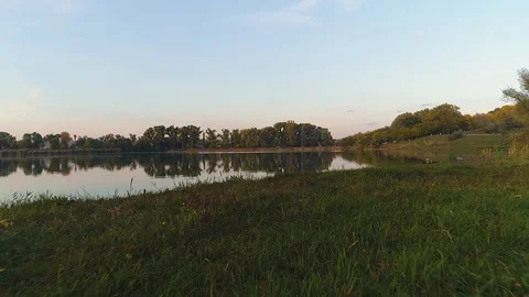 A clean river reflecting an image of the trees in the background. Stock Footage 113426875