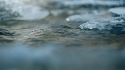 Clean river water flowing during sunny winter day Stock Footage 323767556