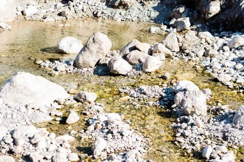 Clean river water flows between the stones Stock Photos