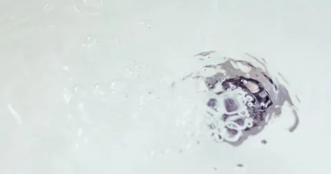 Clean running water flowing into a sink drain with bubbles and splashes, wa.. Stock Footage 345647227