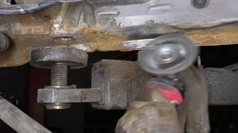 Clean off the rust with a grinder, with a wire brush attachment, Cleaning a Stock Footage 242616683