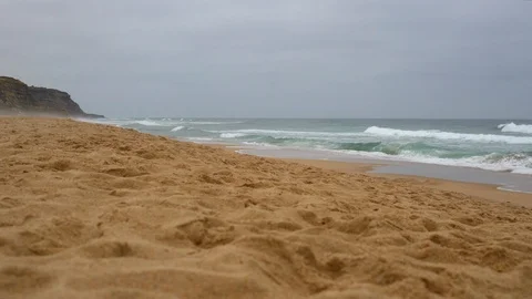 Clean sand by the ocean. Strong ocean waves on a background of high cliffs Stock Footage 116266793