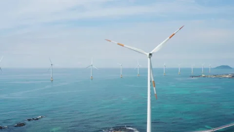Clean sea and eco-friendly energy. Wind turbine and beautiful seascape. Drone Vi Stock Footage