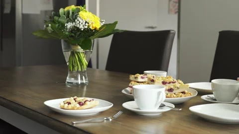 Clean shot of set table with cake, hand setting down cup and taking cake Stock Footage 172412157