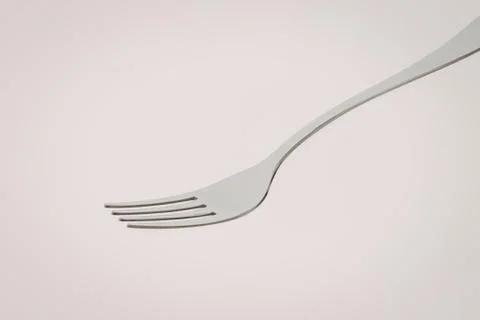 Clean silver dining fork on white background Stock Photos