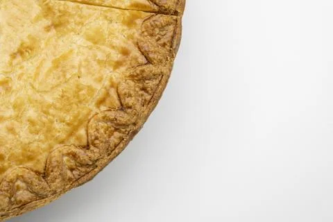 Clean simple close up view of quarter of pie with a slice cut out on a white 写真素材