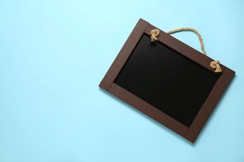 Clean small black chalkboard on light blue background, top view. Space for te Stock Photos