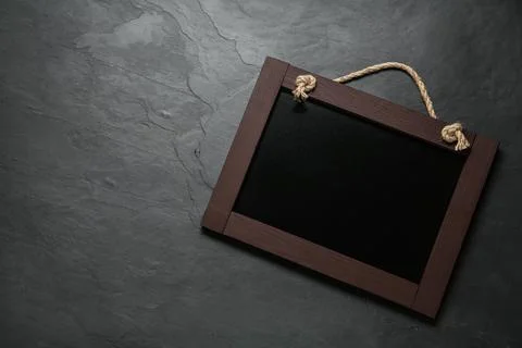 Clean small black chalkboard on table, top view. Space for text Stock Photos