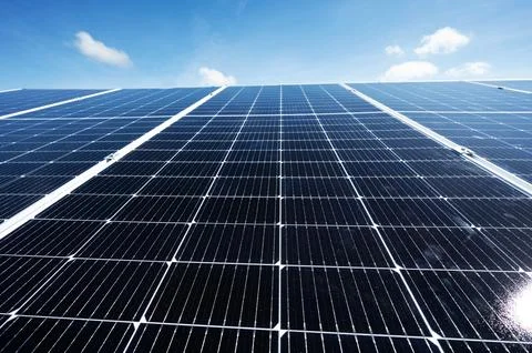 Clean solar panel array on blue sky background Stock Photos