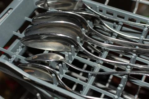Clean spoons in the dishwasher Stock Photos