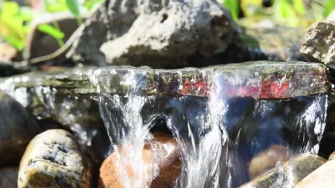 Clean spring water falling from the stones as waterfall in daylight Stock Footage 148530736