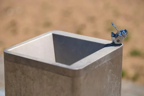 A clean, static shot of an empty public drinking fountain Stock Photos