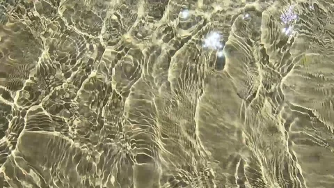 Clean sunlight surface water motion with ripple wave near the shore Stock Footage 126491696