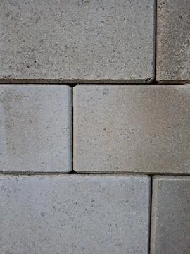 Clean textured stone paving blocks arranged in a repeating pattern Stock Photos