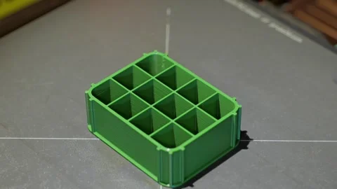 Clean timelapse showing the 3D printing process of a miniature green battery Stock-Footage 345095021