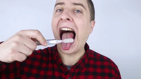 Clean tongue. Close-up of a man performing antimicrobial hygiene with a special  Stock Footage 177448316