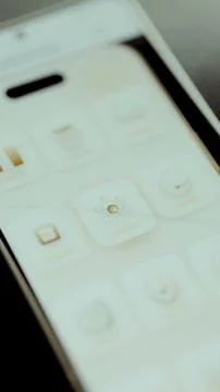 Clean vertical smartphone interface centers a refined gold network hub Stock Photos